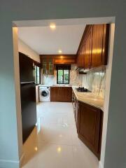 Modern kitchen with wooden cabinets and marble countertops