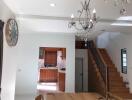 Open-plan living area with a view of the kitchen and staircase