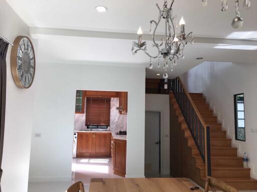 Open-plan living area with a view of the kitchen and staircase