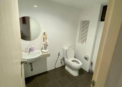 Modern bathroom with sink, toilet, and mirror