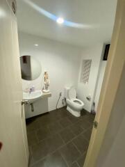 Modern bathroom with sink, toilet, and mirror