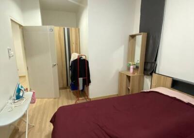 Modern bedroom with wooden flooring and wardrobe