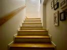 Indoor staircase with wooden steps and wall-mounted handrail