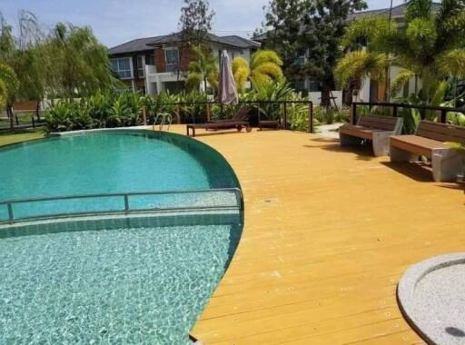 A view of the outdoor swimming pool with surrounding greenery and seating area