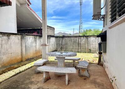 Outdoor patio area with concrete furniture