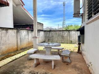 Outdoor patio area with concrete furniture