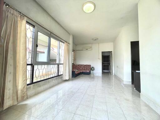 spacious living room with large windows and tiled floor