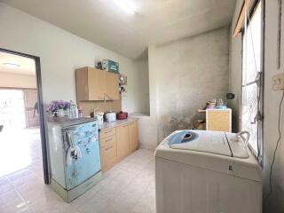 Simple kitchen with vintage refrigerator and washing machine