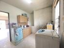 Simple kitchen with vintage refrigerator and washing machine