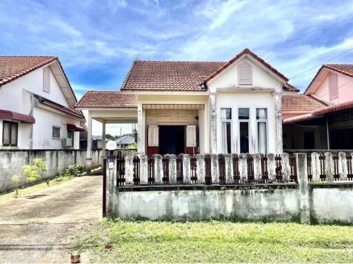 Front view of a house with a driveway and front yard.