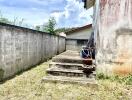 Small outdoor area with concrete steps and wall