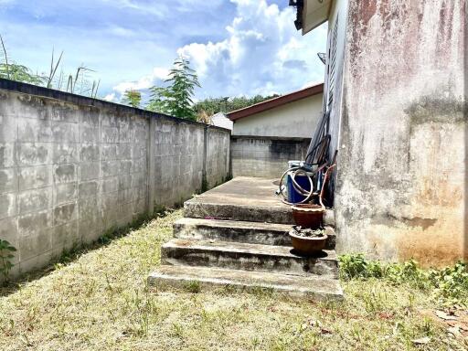 Small outdoor area with concrete steps and wall