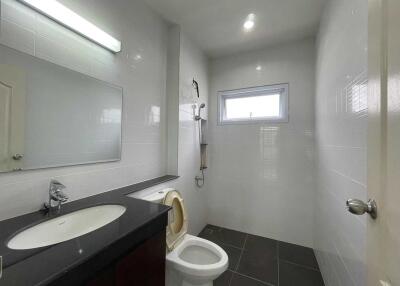 Modern bathroom with sink, toilet, and shower