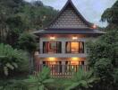 A two-story house surrounded by lush greenery