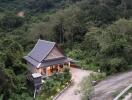 House surrounded by lush greenery and forest