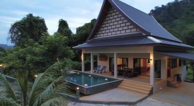 Beautiful exterior view of a two-story house with a pool