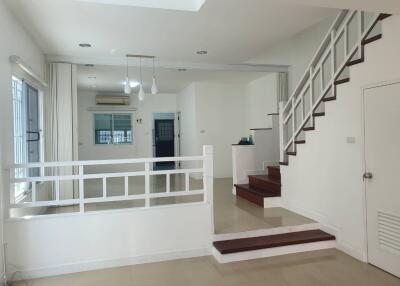 Modern living room with staircase and pendant lighting