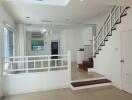 Modern living room with staircase and pendant lighting