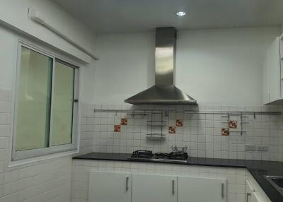 Modern kitchen with built-in stove and range hood