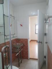 Bathroom with glass washbasin and shower