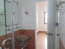 Bathroom with glass washbasin and shower