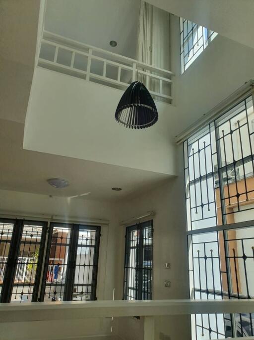 Modern living room with high ceiling and large windows