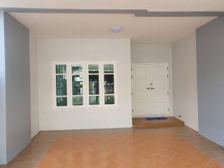 Main entrance with tiled flooring and white double doors