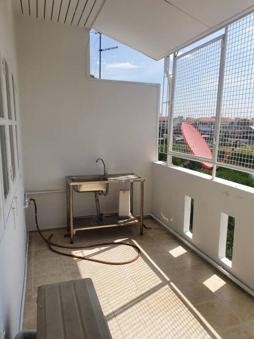 Balcony with stainless steel sink and open views