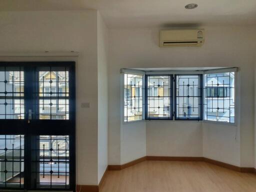 Bright room with large windows and air conditioner