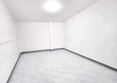 Empty white room with tile floor