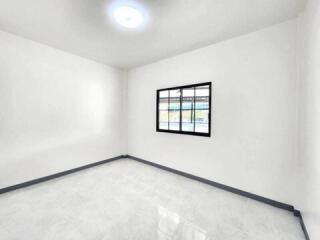 Minimalist white bedroom with a window