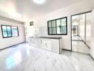 Bright and spacious kitchen with white cabinetry and tiled backsplash