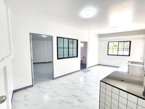 Modern kitchen with white marble flooring and ample natural light