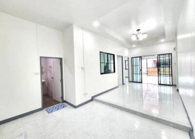 Spacious bright living room with tiled floor and large windows