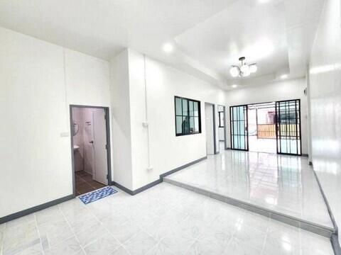 Spacious bright living room with tiled floor and large windows