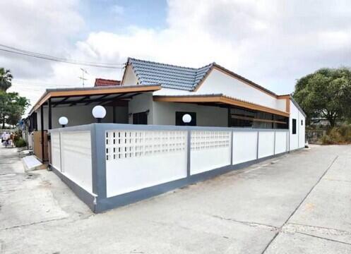 Modern single-story house with white exterior walls and blue roof