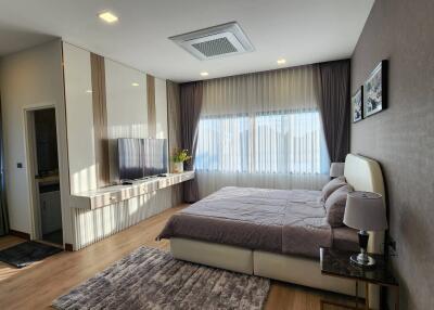 Spacious modern bedroom with large windows