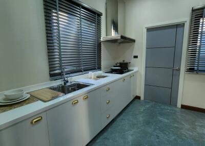 Modern kitchen with white cabinets and stainless steel appliances