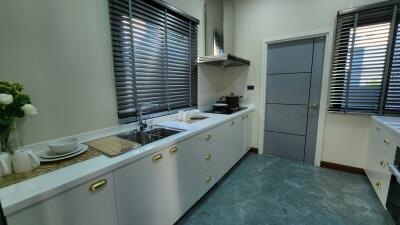 Modern kitchen with white cabinets and stainless steel appliances