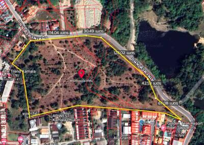 Aerial view of a plot of land marked for sale with surrounding infrastructure