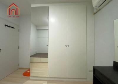 Bedroom with built-in wardrobe and air conditioner
