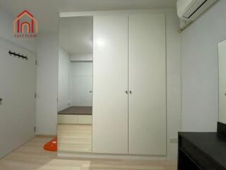 Bedroom with built-in wardrobe and air conditioner