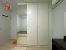 Bedroom with built-in wardrobe and air conditioner