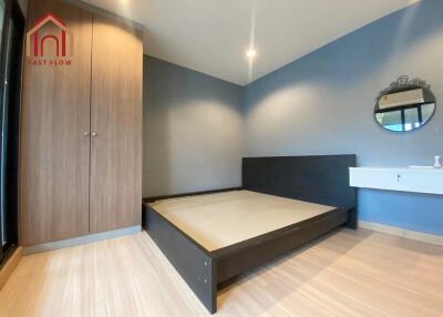 Modern bedroom with wooden floors and built-in wardrobe
