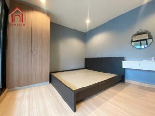 Modern bedroom with wooden floors and built-in wardrobe