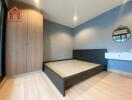 Modern bedroom with wooden floors and built-in wardrobe