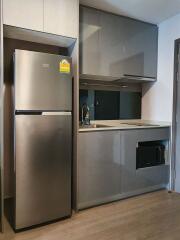 Modern kitchen with grey cabinets and stainless steel appliances