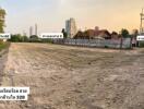 Vacant land with cityscape in background