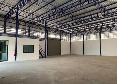 Large empty industrial warehouse with steel framework