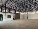 Large empty industrial warehouse with steel framework